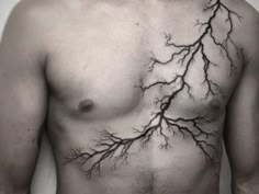 a man's chest with branches on it