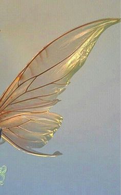 there is a glass figurine that looks like a fairy with wings on it