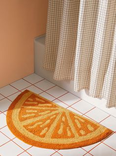 an orange rug sitting on the floor next to a shower