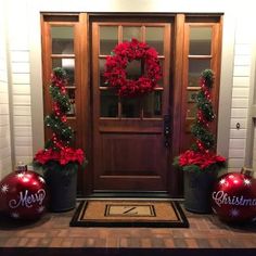 two christmas decorations are on the front porch