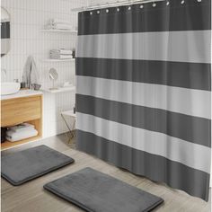 a bathroom with two rugs and a shower curtain