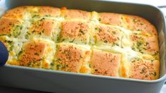 a casserole dish with cheese and broccoli in it on a table