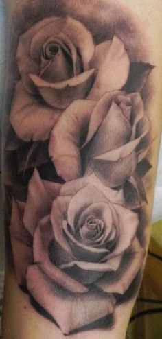 black and white roses tattoo on the arm