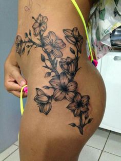 a woman's back with flowers on it and the bottom part of her stomach