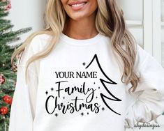 a woman wearing a white sweatshirt with the words your name family christmas written on it