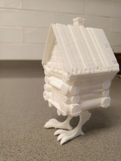 a small white bird house sitting on top of a counter