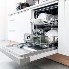 an open dishwasher with dishes in it