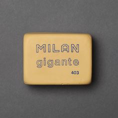 a yellow square shaped object with the words millan giante on it's side