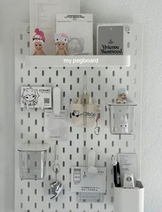 a white pegboard with various items on it