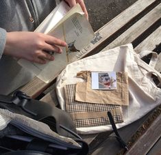 a person sitting on a bench reading a book