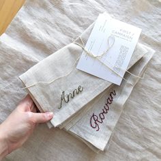 three napkins that have been embroidered onto each other with the words anne and crown on them