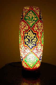 a colorful vase sitting on top of a table