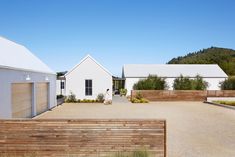 a white house with a wooden fence in front of it