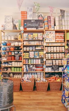 a store filled with lots of items and baskets on the floor in front of it