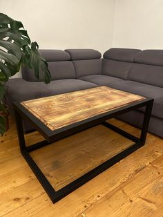 a living room with a gray couch and wooden table on the floor in front of it