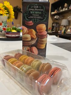 a box of macaroons sitting on top of a counter