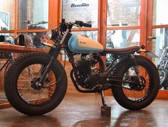 a motorcycle parked in front of a store window