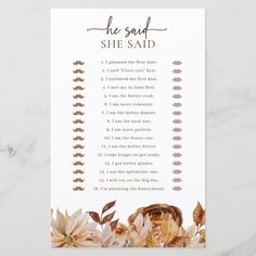 a card with the words she said and flowers in gold foil on white marble background