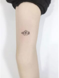 a small flower tattoo on the leg