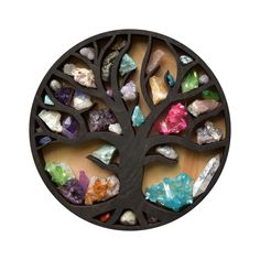 a metal tree with colorful rocks in the center on a wooden surface, against a white background