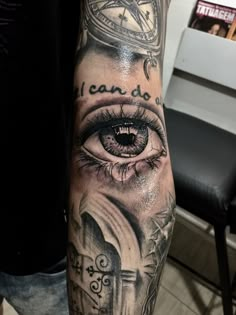 a person with a clock and eye tattoo on their arm