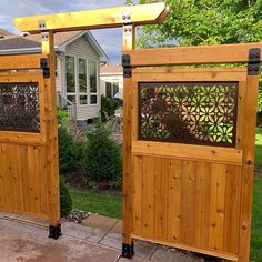 two wooden gates with laser cut designs on them