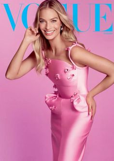 a woman in a pink dress on the cover of a magazine with her hands behind her head