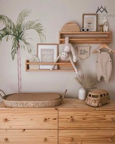 a baby's room is decorated in neutral tones with palm trees and other items