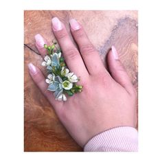 a woman's hand with flowers on it