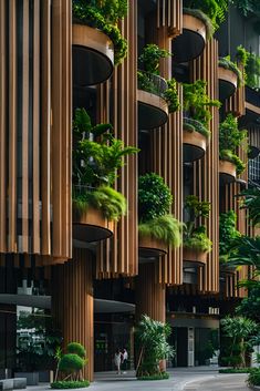 an architecturally designed building with plants growing on the sides and balconies above it