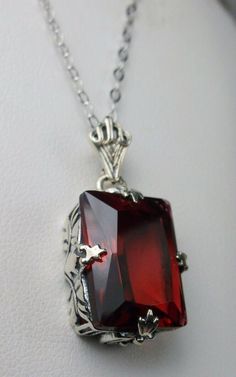 "Simulated Red Ruby Pendant & Earrings GL Design#15 Custom Made Pendant (P15) This is an Art Deco style sterling silver filigree 10 carat Simulated/man-made red ruby pendant necklace. The beautiful rectangle-cut ruby gem is 16mm x 12mm. The 1.5mm necklace chain (if chosen) is adjustable from 18\"-20\". The entire pendant is 1 1/8\" long by 9/16\" wide. Notice the beautiful craftsmanship of the silver Art Deco filigree bail. The earrings are 16mm x 12mm each and 1 5/16\" long. The dazzling ge Formal Hallmarked Pendant Jewelry, Fine Gemstone Jewelry For Valentine's Day, Fine Jewelry Gemstone For Valentine's Day, Classic Red Jewelry As A Gift, Valentine's Day Gemstone Fine Jewelry, Valentine's Day Fine Jewelry With Gemstones, Formal Octagon Ruby Jewelry, Classic Formal Jewelry With Jewels, Classic Gemstone Jewelry For Valentine's Day