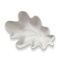 a white leaf shaped dish on a white background