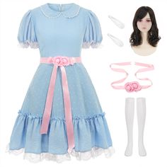 a doll is wearing a blue dress with pink bows