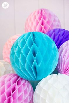 paper honeycombs are stacked on top of each other in pastel hues