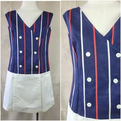 Brand: unknown Size: M; see measurements below  Color: red, white and blue Fabric Content: 100% cotton    Features:  This fresh, summer skort dress will add fun to any summer event. The v-neckline, scoop back neck has vertical slimming red and white stripes on a navy background. The front is double breasted with 6 white buttons up the front. The dropped waist white skirt has a front and back panel which hides the skort part of the dress. Sail on sailor girl!    Measurements: Bust/Chest: 36" Waist: 34.5" Hip: 37" Shoulder to Shoulder: 14.75 Center Back Length: bottom of scoop to hem:27.5"   Condition: Excellent, appears unworn    Care: Machine wash cold water gentle cycle hang dry.  Vintage sizing varies. Please check your measurements thoroughly and ask any questions before your purchase. Summer Skort, Skort Romper, Skort Dress, Womens Jumpsuits, Athletic Style, Fresh Summer, Navy Background, White Button Up, White Skirt