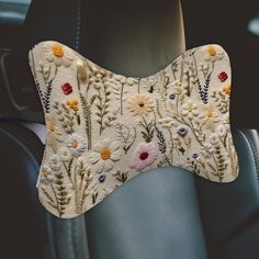 a car seat cushion with flowers on it