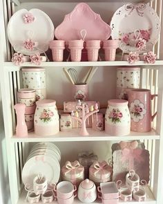 a shelf filled with lots of pink and white dishes