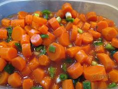 carrots and celery are being cooked in a pan