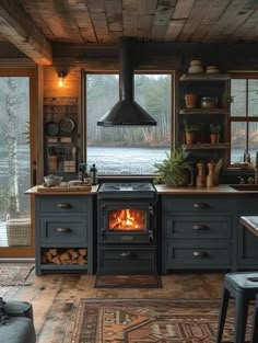 a stove top oven sitting inside of a kitchen next to a wooden ceiling and windows