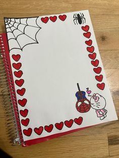 a notebook with hearts and spider web on it