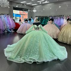 there are many gowns on display in the store, all different colors and sizes