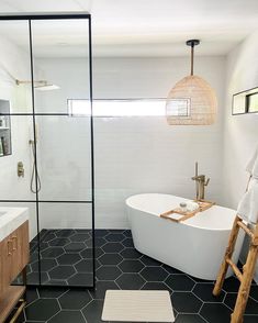 a white bath tub sitting next to a walk in shower