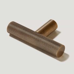 two wooden rollers sitting next to each other