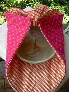 a white plate sitting on top of a table next to a pink and orange bow