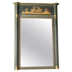 a green and gold framed mirror sitting on top of a wall