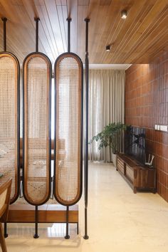 the room dividers are made out of caned wood and have woven screens on them