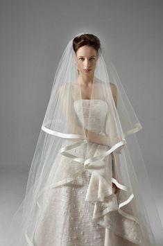 a woman wearing a wedding dress and veil