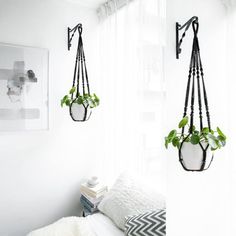 two hanging planters in the corner of a bedroom