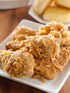 fried chicken is on a white plate next to other food items and the words, kfc chicken recipe