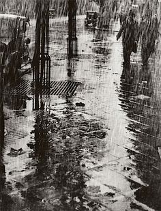 a black and white photo of people walking in the rain